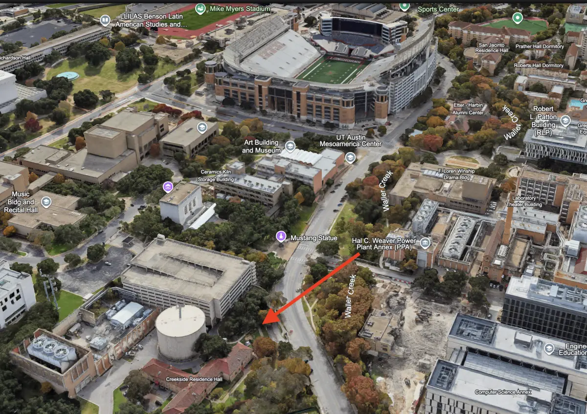 Aerial view of the UT campus around DKR–Texas Memorial Stadium; an arrow marks the UT Tailgaters spot at Dean Keaton and San Jacinto